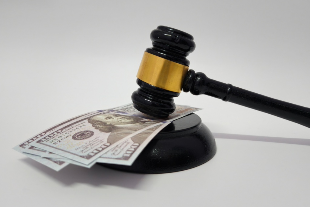 Judge's gavel resting on hundred-dollar bills — Illinois condo eviction and money judgment for unpaid assessments