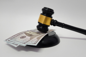 Judge's gavel resting on hundred-dollar bills — Illinois condo eviction and money judgment for unpaid assessments